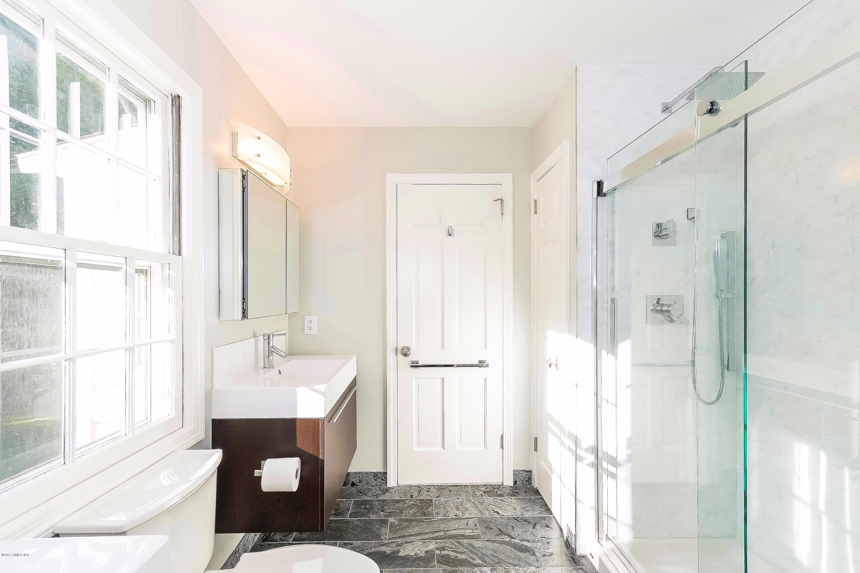 85 Perkins Road Greenwich, CT 06830 - Photo 23 of 36 a bath room with a sink and a mirror