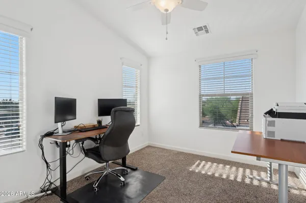 a view of a workspace with furniture and a window