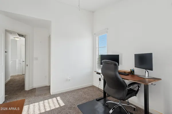 a view of a workspace with furniture and wooden floor