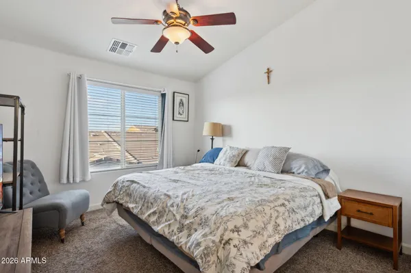 a bedroom with a bed couch and a window