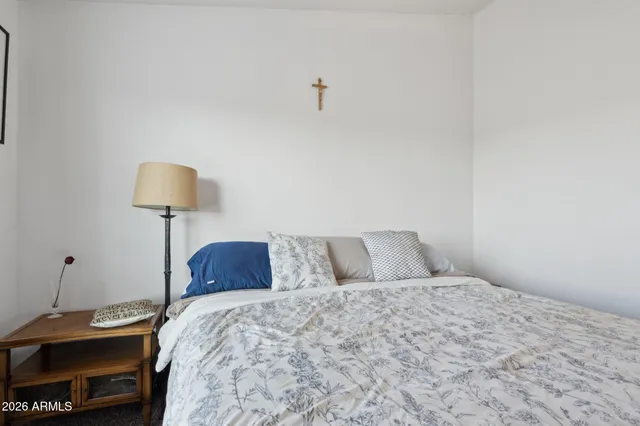 a bedroom with a bed and a lamp