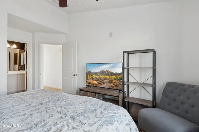 a bedroom with a bed and glass windows