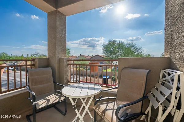 a view of a balcony with a table and chairs