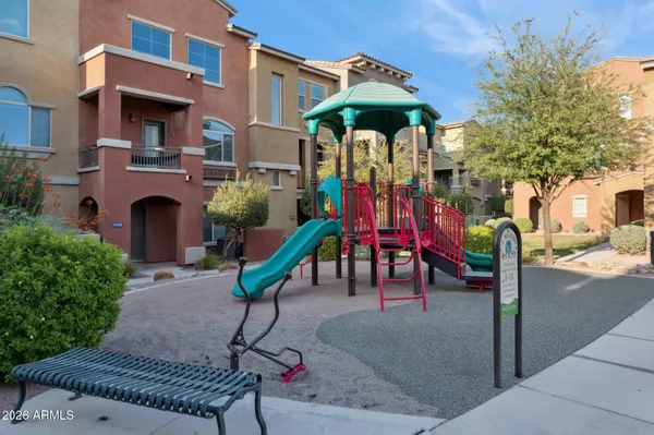 a view of a fountain with an umbrella and a fire pit