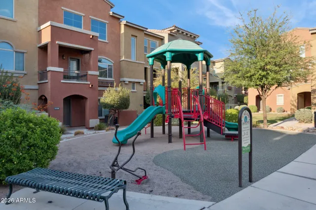 a view of a fountain with an umbrella and a fire pit