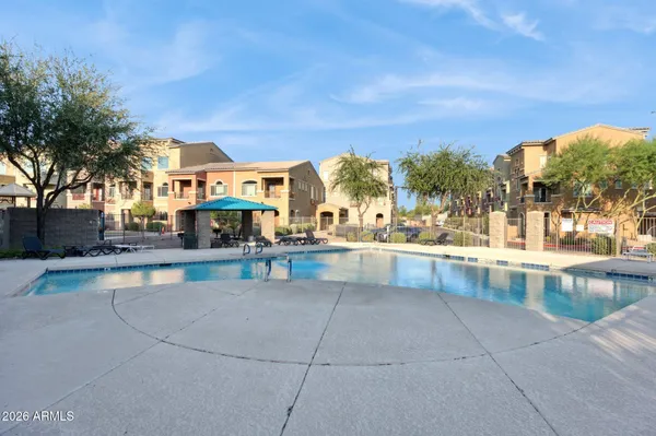 a view of a swimming pool with outdoor seating