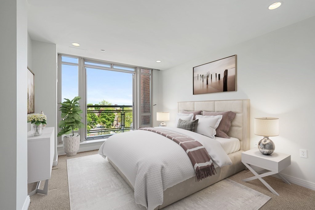 1910 Dorchester Avenue, Unit 601 Boston, MA 02124 - Photo 5 of 15 a bedroom with a large bed and a large window