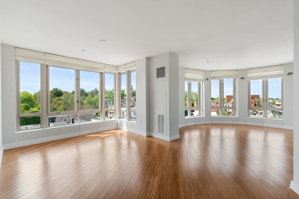 1910 Dorchester Avenue, Unit 601 Boston, MA 02124 - Photo 6 of 15 a view of an empty room with wooden floor and a window