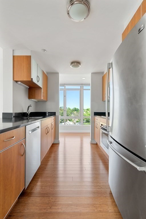 1910 Dorchester Avenue, Unit 601 Boston, MA 02124 - Photo 7 of 15 a kitchen with stainless steel appliances granite countertop a stove a sink and a refrigerator