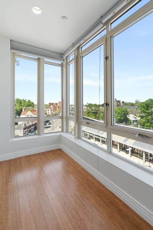 1910 Dorchester Avenue, Unit 601 Boston, MA 02124 - Photo 8 of 15 a view of an empty room with wooden floor and a window