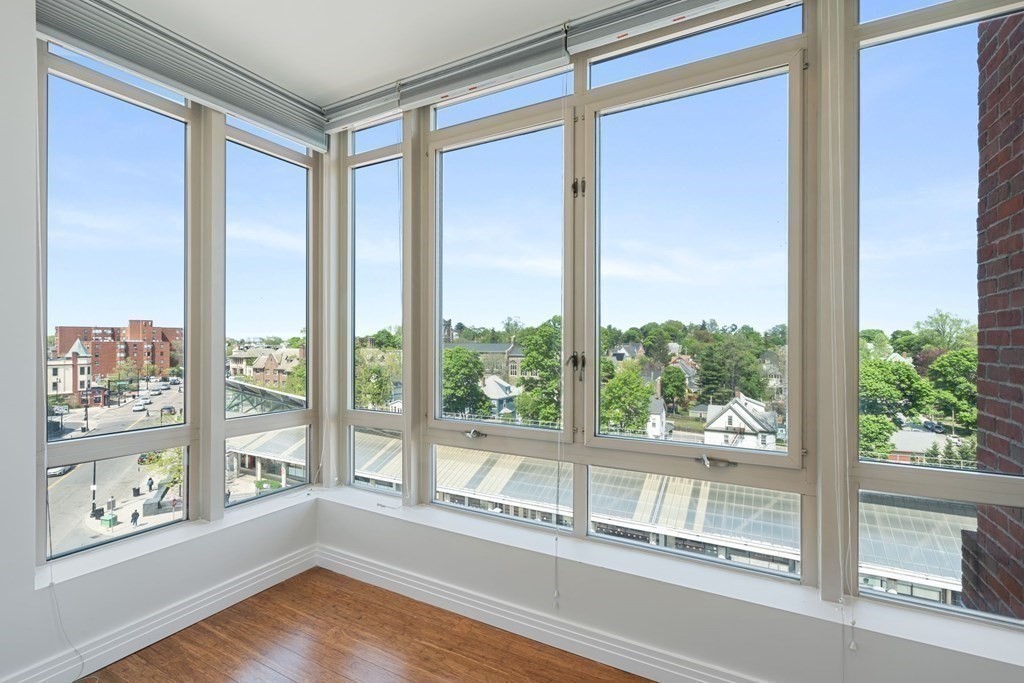 1910 Dorchester Avenue, Unit 601 Boston, MA 02124 - Photo 9 of 15 a view of an empty room with wooden floor and a window