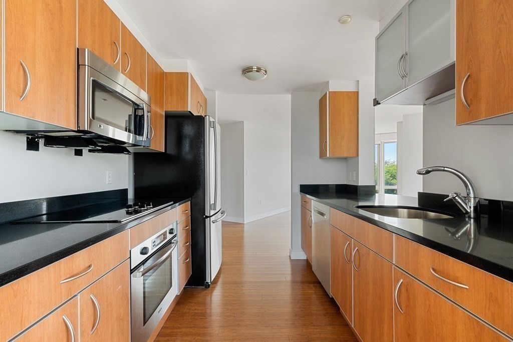 1910 Dorchester Avenue, Unit 601 Boston, MA 02124 - Photo 10 of 15 a kitchen with stainless steel appliances a sink a stove and a microwave