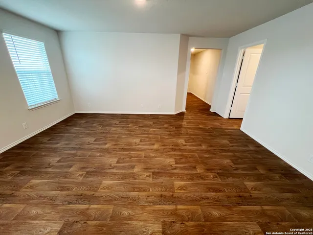 a kitchen with a sink and wooden floor
