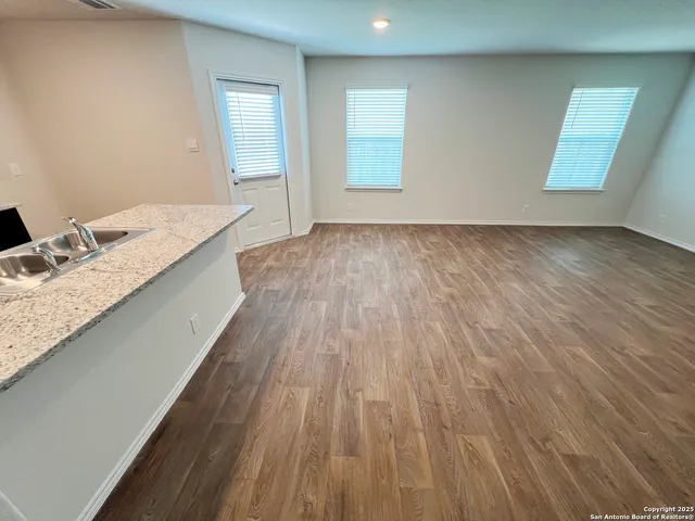 an empty room with a ceiling fan and carpet