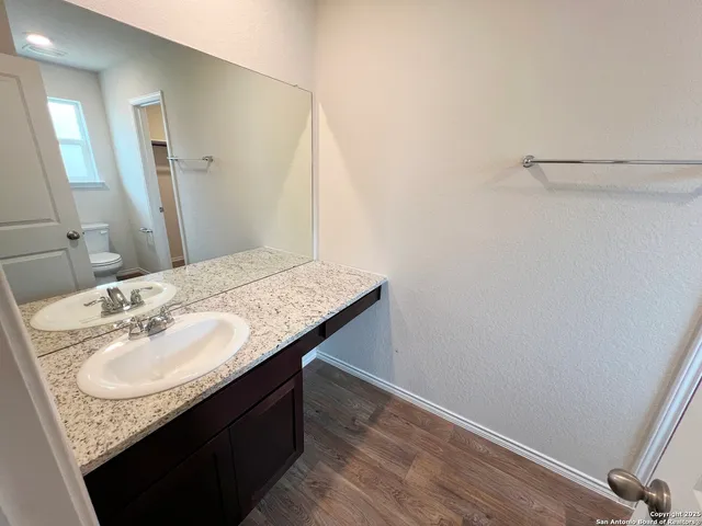 a white toilet sitting next to a bath tub