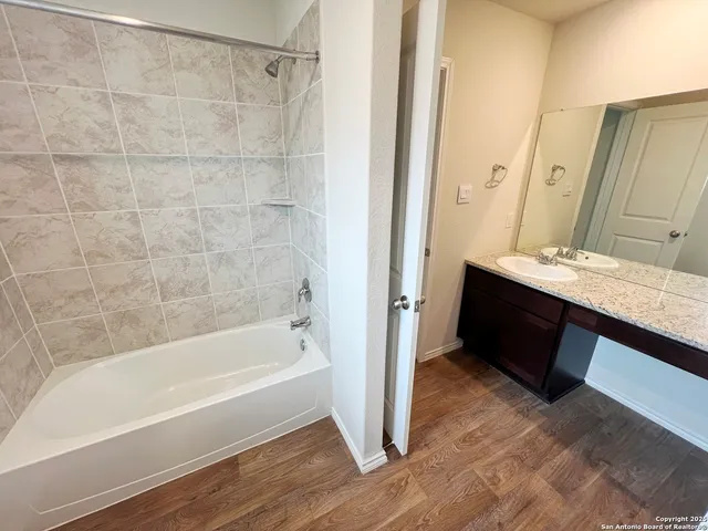 a bath tub sitting next to a white sink
