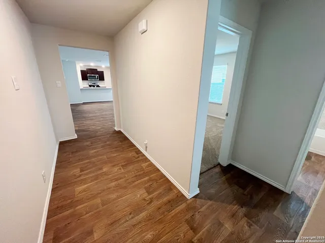 a view of a hallway view with wooden floor and staircase