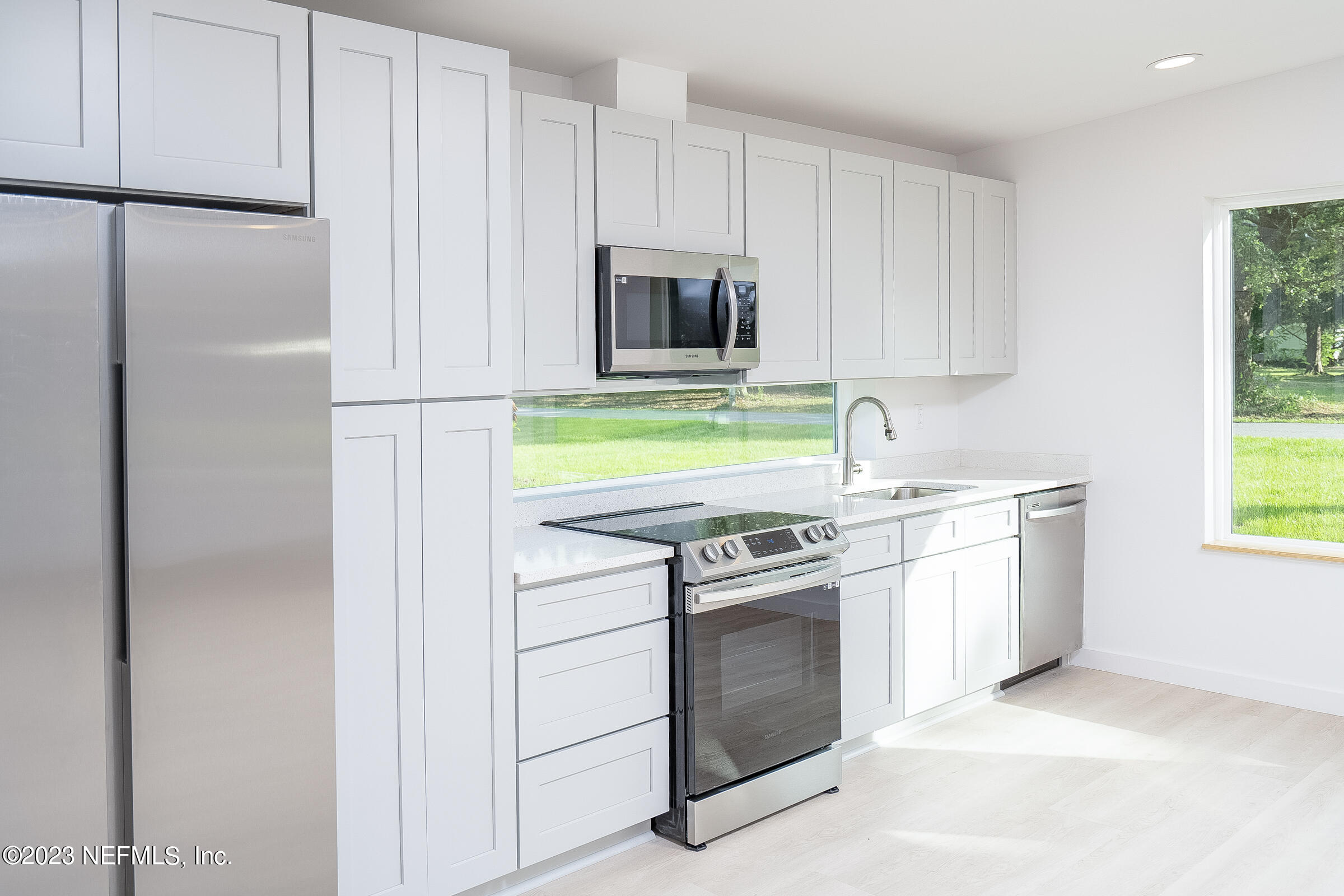 210 Yarbrough Road St. Augustine, FL 32095 - Photo 12 of 34 a kitchen with a stove and a microwave