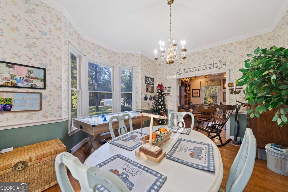 385 Stembridge Road Southeast Milledgeville, GA 31061 - Photo 12 of 81 a view of a dining room with furniture a chandelier and wooden floor