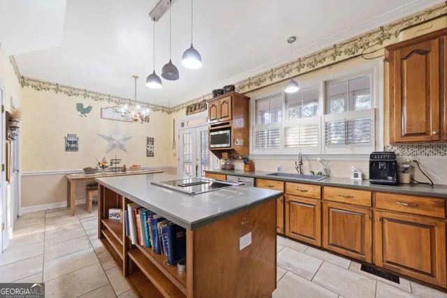 a large kitchen with stainless steel appliances granite countertop a stove a sink dishwasher and cabinets with wooden floor