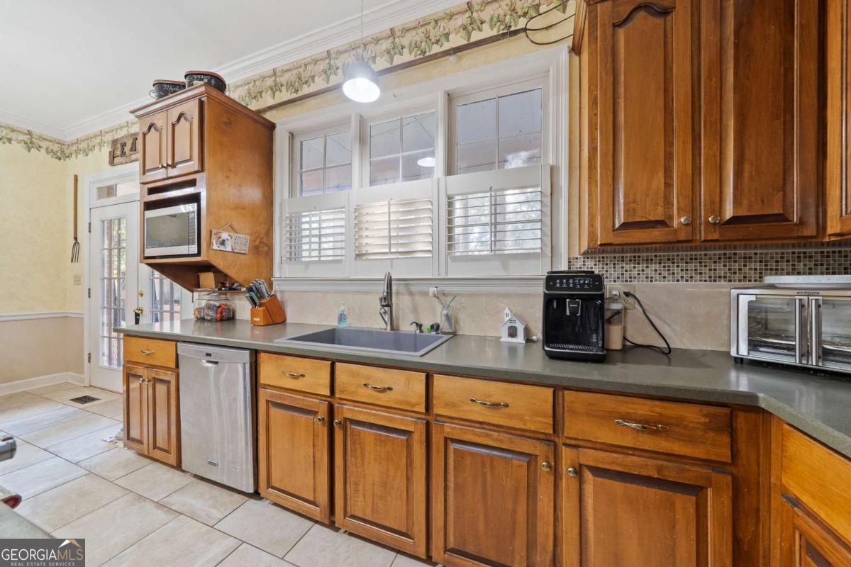385 Stembridge Road Southeast Milledgeville, GA 31061 - Photo 18 of 81 a kitchen with stainless steel appliances granite countertop a sink and cabinets
