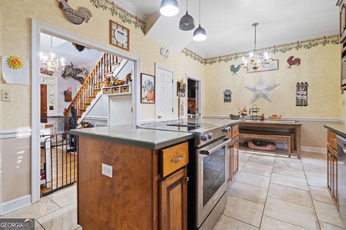 385 Stembridge Road Southeast Milledgeville, GA 31061 - Photo 19 of 81 a kitchen with stainless steel appliances granite countertop a stove and a refrigerator