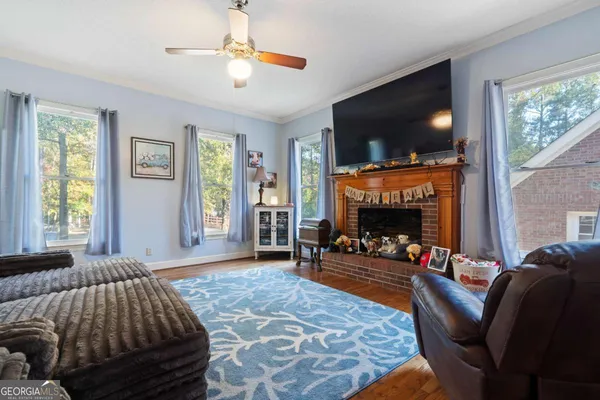 a living room with furniture and wooden floor