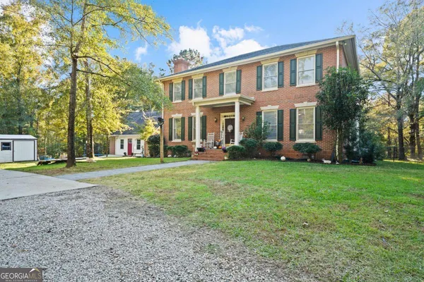 a front view of a house with garden