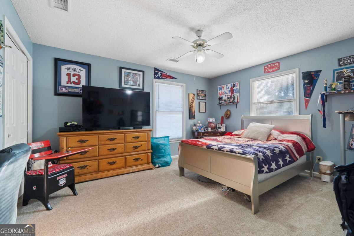 385 Stembridge Road Southeast Milledgeville, GA 31061 - Photo 32 of 81 a bedroom with a bed and a flat screen tv