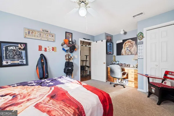 a view of a backyard with potted plants and large tree