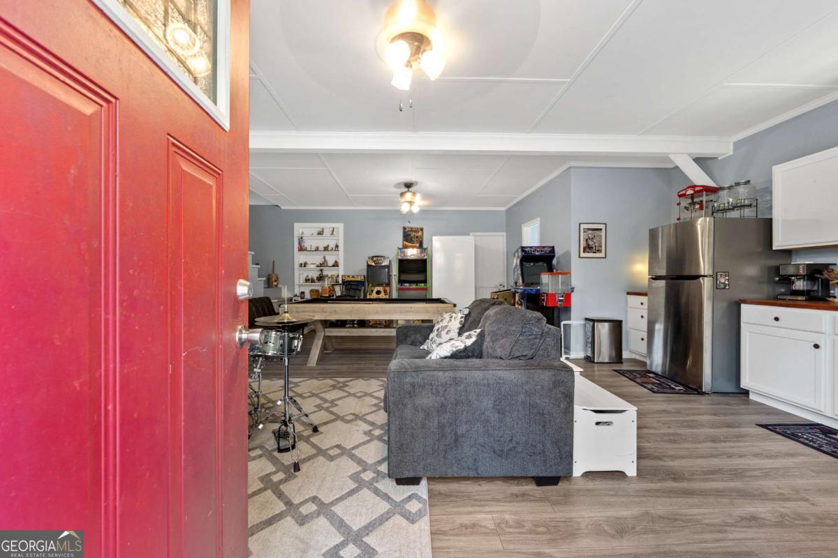385 Stembridge Road Southeast Milledgeville, GA 31061 - Photo 38 of 81 a living room with furniture a flat screen tv and kitchen view