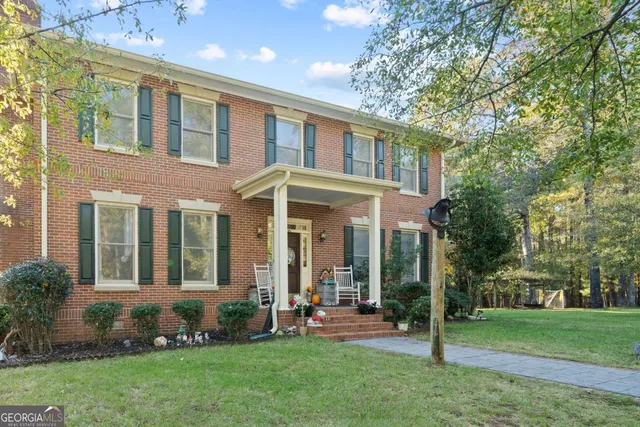 front view of a brick house with a yard