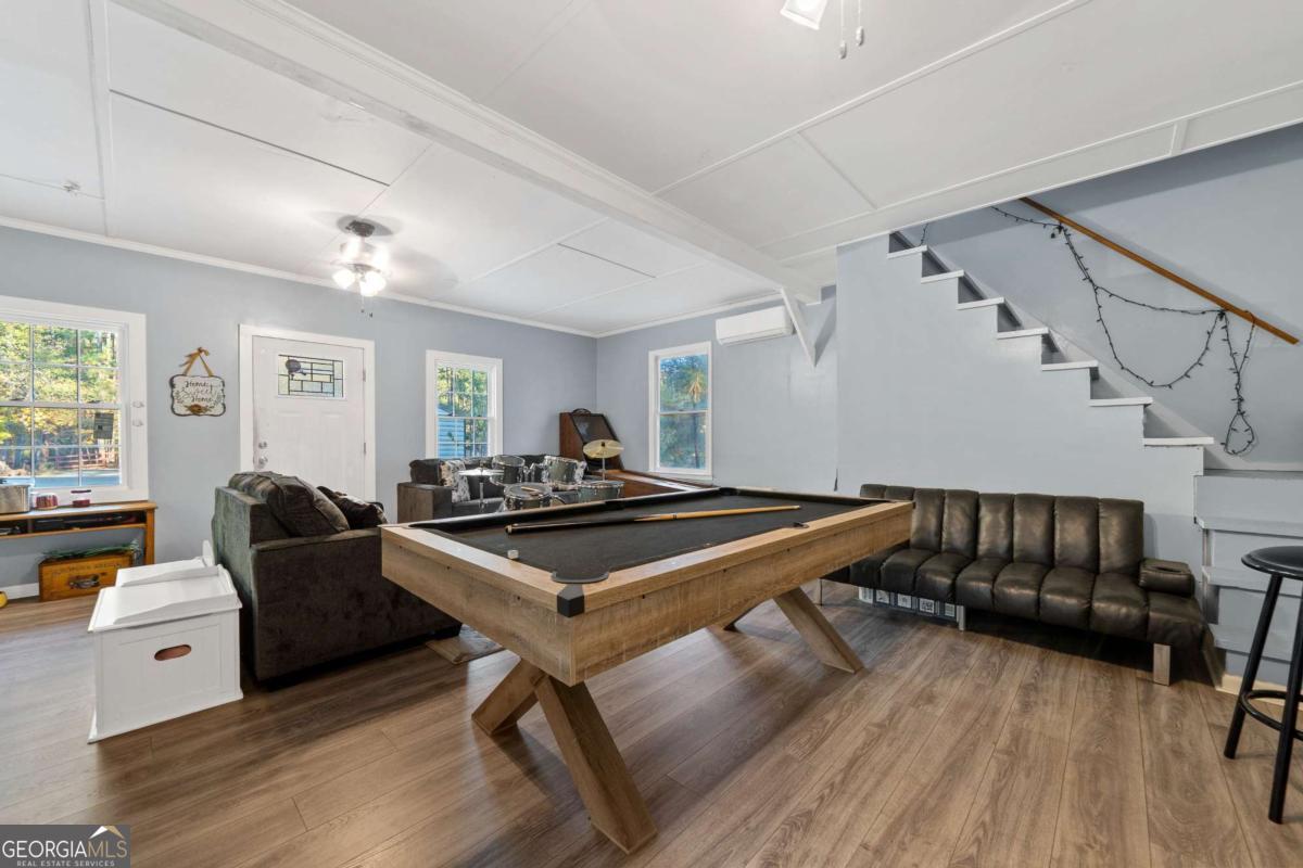 385 Stembridge Road Southeast Milledgeville, GA 31061 - Photo 41 of 81 a living room with furniture a wooden floor and a window