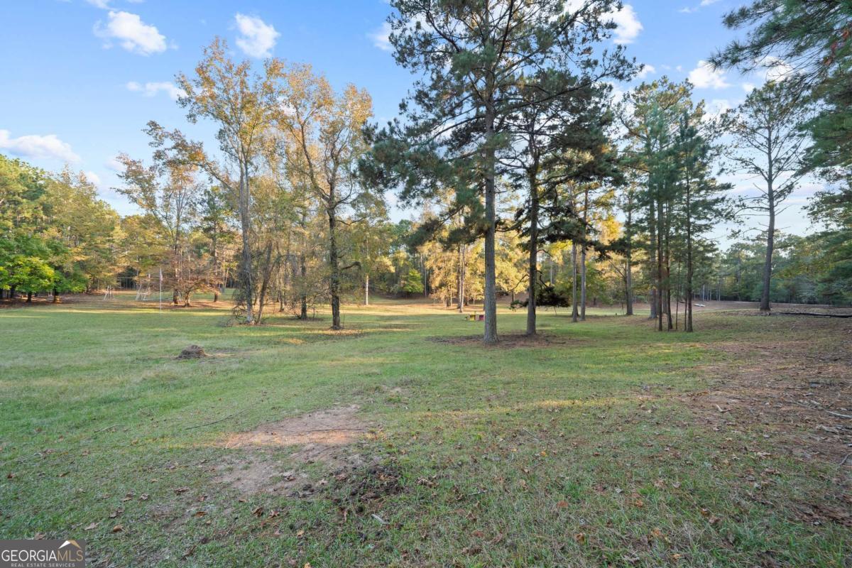 385 Stembridge Road Southeast Milledgeville, GA 31061 - Photo 47 of 81 a view of outdoor space with green field and trees