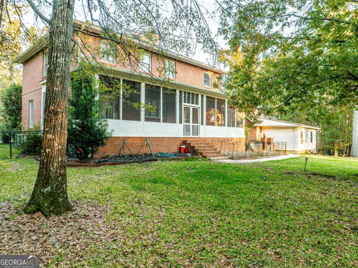 385 Stembridge Road Southeast Milledgeville, GA 31061 - Photo 6 of 81 a view of an house with backyard space and garden