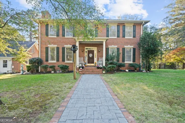 front view of a brick house with a yard