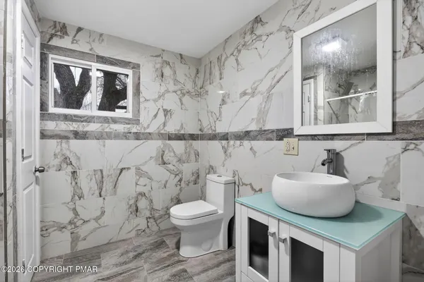 a bathroom with a bathtub and shower