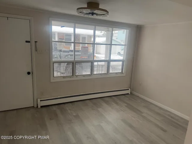 a view of an empty room with a window