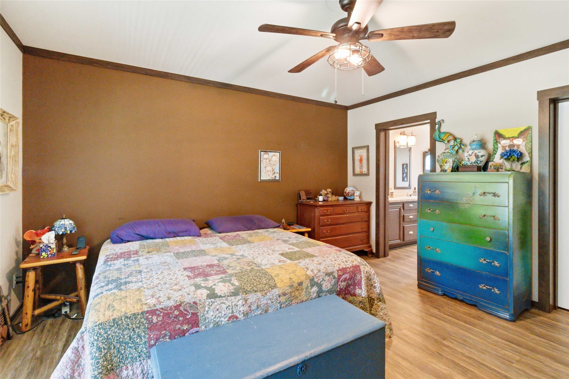 7921 Vista Ranch Road Smithville, TX 78957 - Photo 21 of 39 The private suite offers a peaceful retreat with rich wood-toned flooring and an en-suite bathroom.