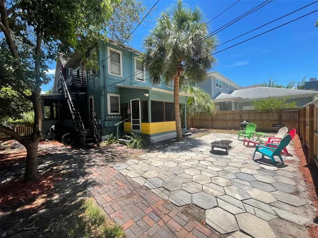 a view of a house with backyard and sitting area