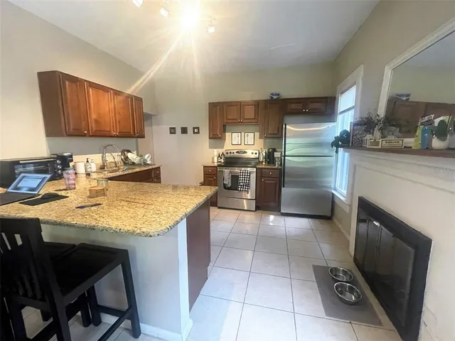 a kitchen with stainless steel appliances granite countertop a sink counter space cabinets and a counter top space