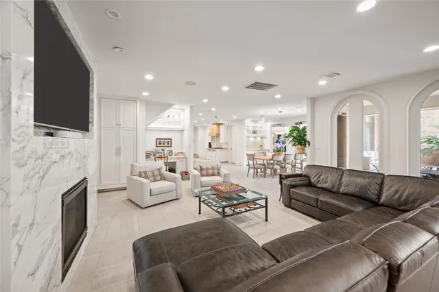 a living room with furniture fireplace and flat screen tv