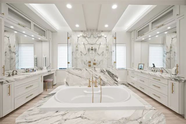 a large bathroom with a double vanity sink a mirror and a bathtub