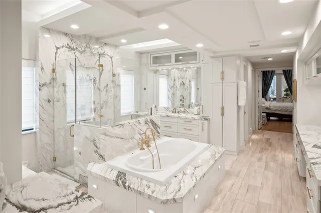 a spacious bathroom with a bathtub shower and a sink