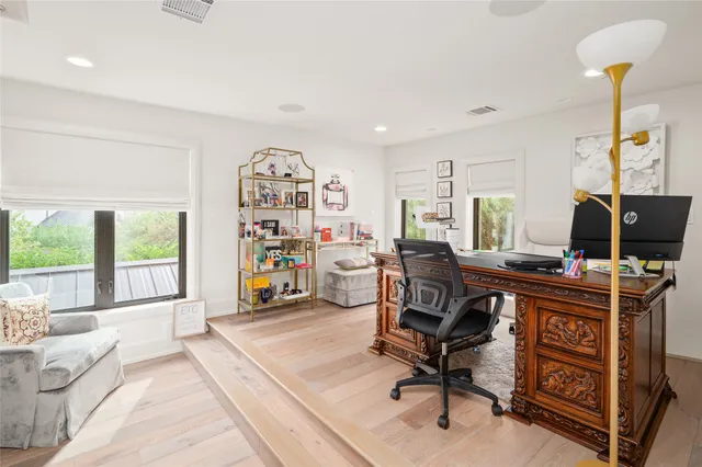 a view of a workspace with furniture and a window