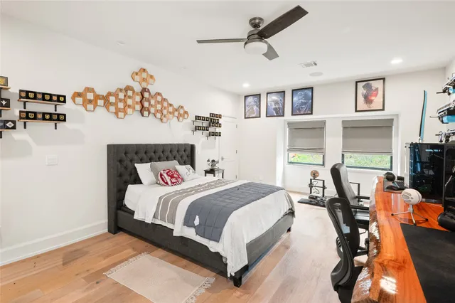 a bedroom with a bed and wooden floor