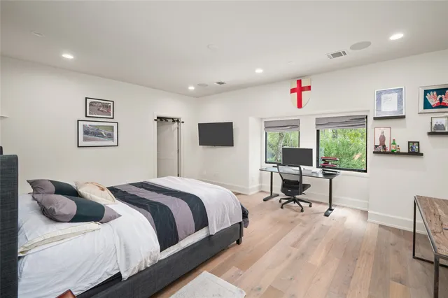 a bedroom with a bed and a desk