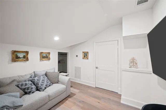 a living room with furniture a table and a large window