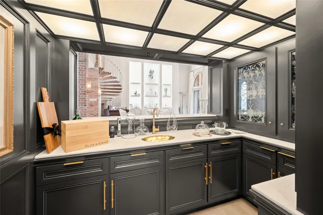 a view of a kitchen with granite countertop a sink and a window