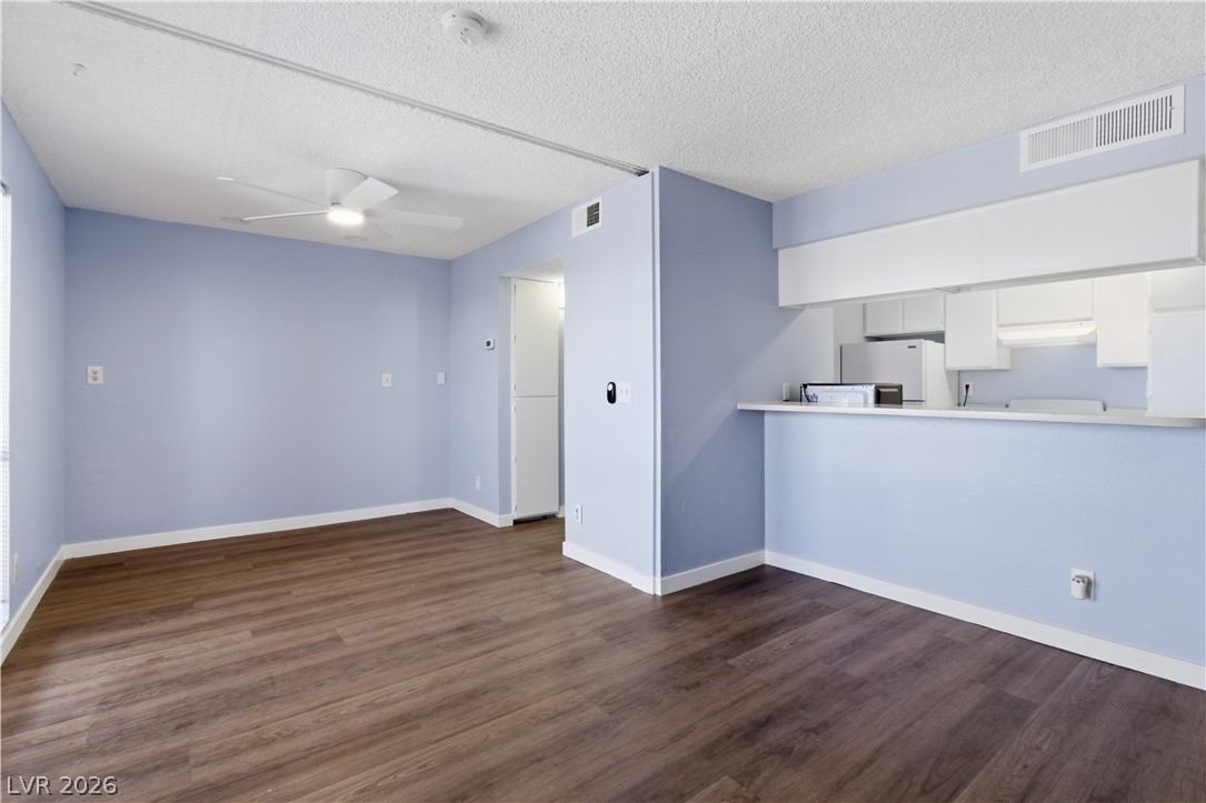 2221 West Bonanza Road, Unit 28 Las Vegas, NV 89106 - Photo 3 of 15 This airy open-concept space features warm wood-toned flooring and an integrated kitchen pass-through.